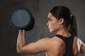 Young woman flexing muscles with dumbbells in gym Royalty Free Stock Photo