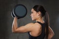 Young woman flexing muscles with dumbbells in gym Royalty Free Stock Photo