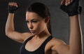 Young woman flexing muscles in gym Royalty Free Stock Photo