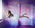 Lost in her dreams. A young woman floating out of a window in a dreamlike state. Royalty Free Stock Photo