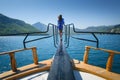 Young woman on the floating yacht on the sea at sunny bright day