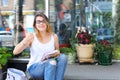 Young woman on the floor on the street looking in camera using p Royalty Free Stock Photo