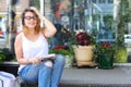 Young woman on the floor on the street looking in camera using p Royalty Free Stock Photo