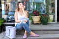 Young woman on the floor on the street looking in camera using p Royalty Free Stock Photo