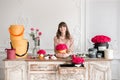 Young woman florist arranging plants in flower shop. People, business, sale and floristry concept. Bouquet of red roses Royalty Free Stock Photo