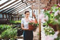 Young woman florist work in garden Royalty Free Stock Photo