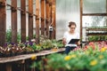 Young woman florist work in garden