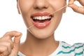 Young woman flossing her teeth on white background, closeup. Cosmetic dentistry Royalty Free Stock Photo