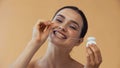 young woman flossing teeth while looking Royalty Free Stock Photo