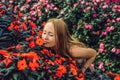 Young woman in a flower greenhouse. Bright tropical flowers.