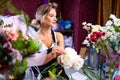 young woman flower store manager standing at workplace and smiling reopening shop sale Royalty Free Stock Photo