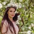 Young woman in flowers outdoors. Perfect female model in blossom garden Royalty Free Stock Photo