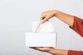 Hand taking pulling white facial tissue out of from a white box Royalty Free Stock Photo