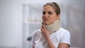 Young woman in foam cervical collar feeling sharp pain in neck, trauma result Royalty Free Stock Photo