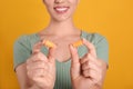 Young woman with foam ear plugs on yellow background, closeup Royalty Free Stock Photo