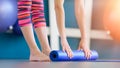 Young woman folding blue yoga or fitness mat after working out Royalty Free Stock Photo