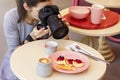 Young woman food photographer blogger shoots Breakfast in cafe Royalty Free Stock Photo