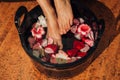 Young woman in foot-bath in oriental herb water for body detox