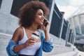 Young woman free style on the street sitting on stairs drinking Royalty Free Stock Photo