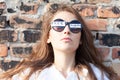 Young woman with freedom sign on sunglasses