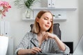 Young woman freelance graphic designer working using graphic tablet and laptop in home office interior. Caucasian Blonde Royalty Free Stock Photo