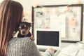 Young woman freelancer indoors home office concept winter atmosphere hugging puppy Royalty Free Stock Photo