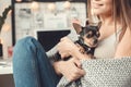 Young woman freelancer indoors home office concept winter atmosphere with puppy close-up Royalty Free Stock Photo
