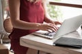 Young woman freelancer typing in laptop in cafe Royalty Free Stock Photo