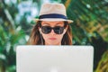 Young woman freelancer working in laptop on the beach. Freelance work Royalty Free Stock Photo