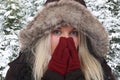 Young woman freezing in the cold in winter in the woods Royalty Free Stock Photo