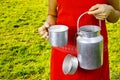 Young woman with fresh organic farm cowmilk in aluminum milk can Royalty Free Stock Photo