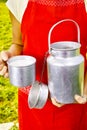 Young woman with fresh organic farm cowmilk in aluminum milk can Royalty Free Stock Photo