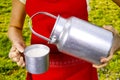 Young woman with fresh organic farm cowmilk in aluminum milk can Royalty Free Stock Photo