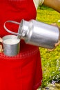 Young woman with fresh organic farm cowmilk in aluminum milk can Royalty Free Stock Photo