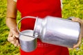 Young woman with fresh organic farm cowmilk in aluminum milk can Royalty Free Stock Photo