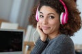 Young woman with frizzy hair wearing headphones