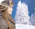 Young woman front of winter landscape smiling
