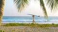 Young woman on fun surfing trip in Barbados carries a surfboard on her head. Royalty Free Stock Photo