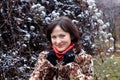 Young woman in fur coat and snow