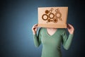 Young woman gesturing with a cardboard box on his head with spur Royalty Free Stock Photo