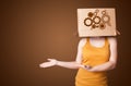 Young woman gesturing with a cardboard box on his head with spur wheels Royalty Free Stock Photo