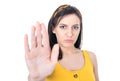 Young woman gesturing stop sign with palm of hand,refuses or reject something, isolated on white background