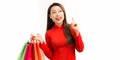 Young woman get surprise look at copy space. Attractive beautiful young asian girl wear Vietnamese dress, holding shopping bags in Royalty Free Stock Photo