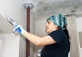 Young woman geting plaster wall