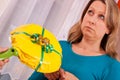 Young woman gets a thoughtless gift Royalty Free Stock Photo
