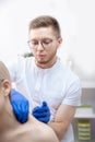 Young woman getting acupuncture treatment to shoulder doctor therapy