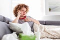 Young woman getting bad news by phone. unhappy woman talking on mobile phone looking down. Crying depressed girl holds phone Royalty Free Stock Photo