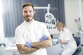 Young woman getting dental treatment while dentist posing