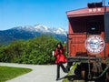 Young woman getting down from train cart Yukon Route