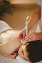 Young woman getting ear candling treatment Royalty Free Stock Photo